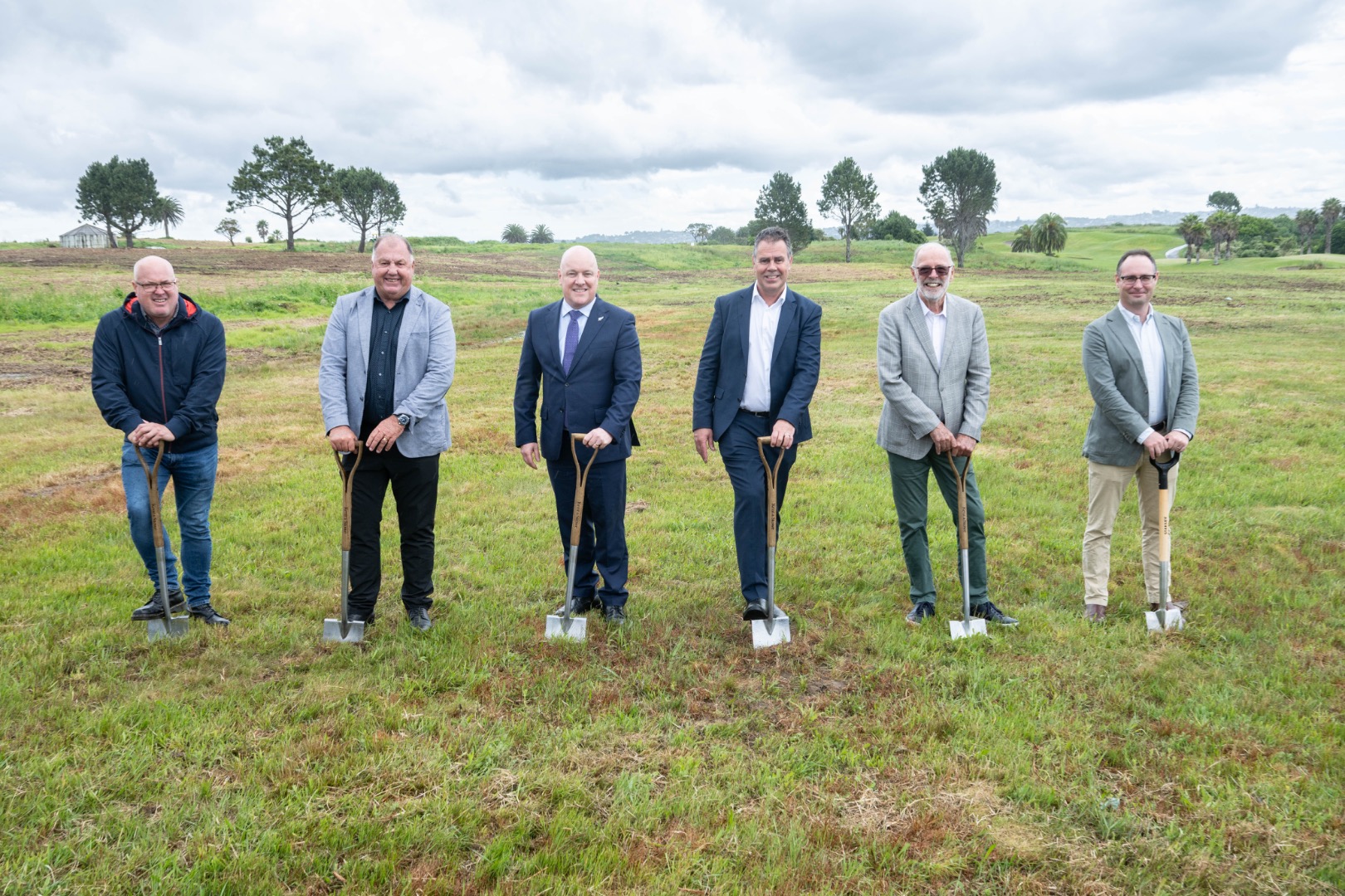 Spades at the ready at the Beachlands sod-turning for the development of a multi-billion dollar scheme. From left: Billy Brown of Ngāti Tai ki Tāmaki, Rob Bassett of Bassett Plumbing & Drainage, Prime Minister Christopher Luxon, Brett Russell of Russell Group, Mayor Wayne Brown, and Will Goodwin of the NZ Super Fund. Credit: Beachlands South Limited Partnership